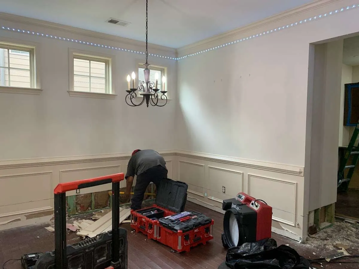 Restoration technician with professional equipment in Newton